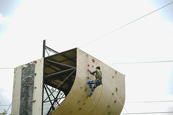 Curved rock climbing wall challenge at Roadies Rostel ARC Resort adventure park
