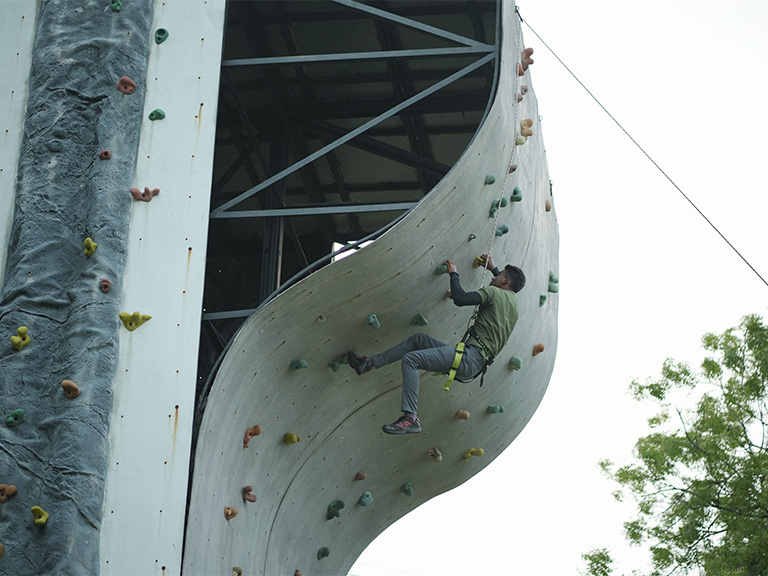 Rock climbing wall activity at adventure park in Roadies Rostel ARC Resort near Ahmedabad
