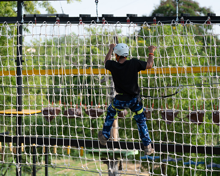 Crossing rope obstacle at adventure park rope course at Roadies Rostel ARC Resort near Ahmedabad