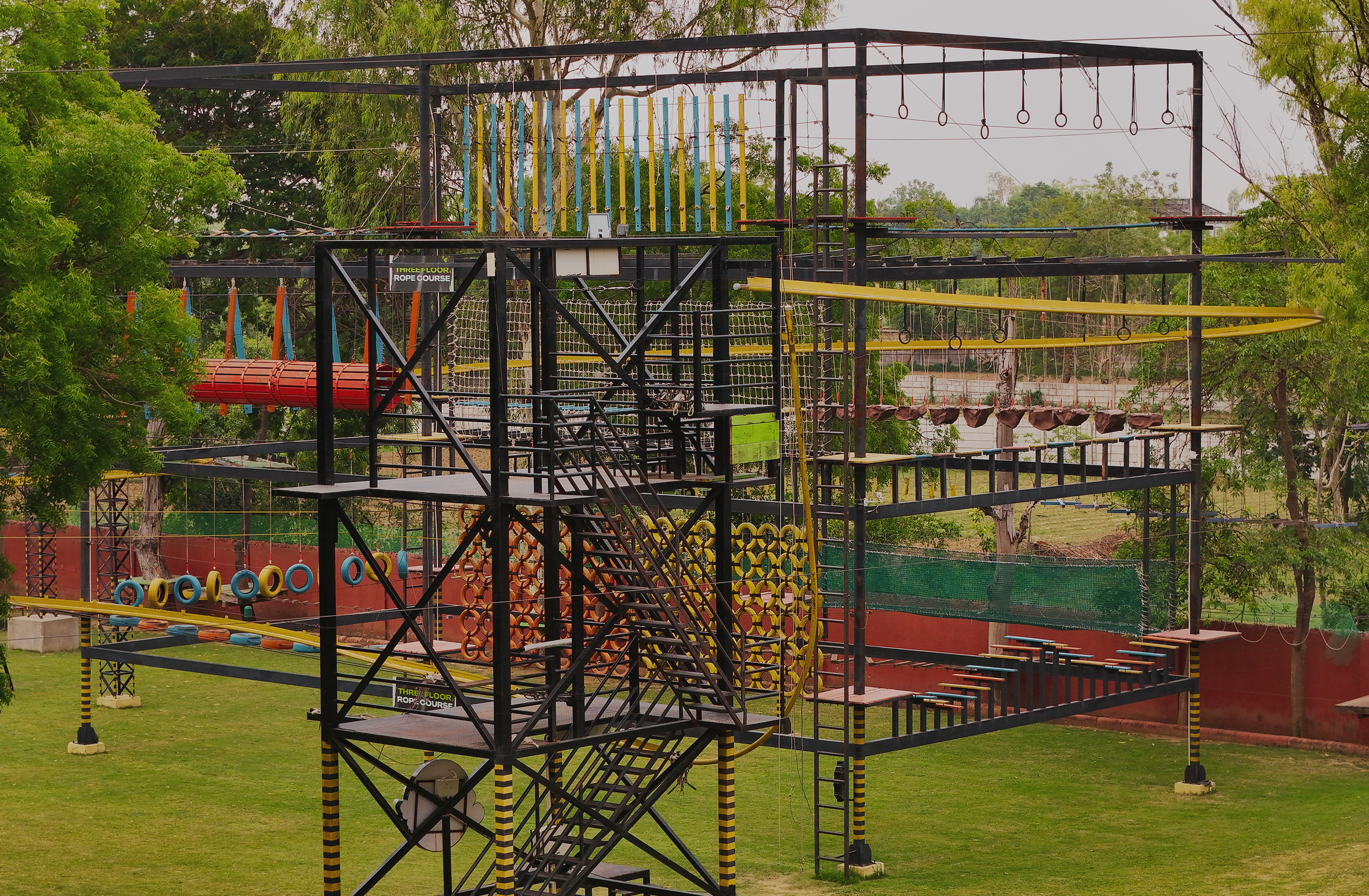 Guest on three-floor rope course at adventure park near Ahmedabad at Roadies Rostel ARC Resort