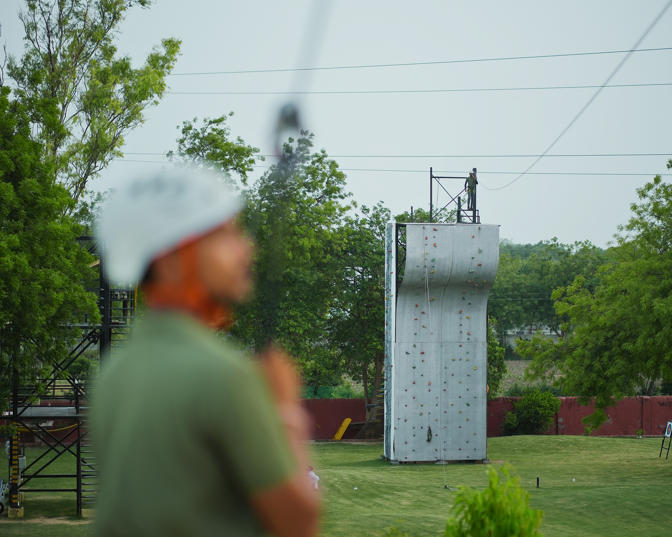 Adventure park view of wall climbing and zipline launch zone near Ahmedabad