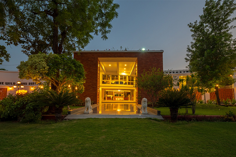 Roadies Rostel ARC Resort entrance at night, ideal celebration venue near Ahmedabad