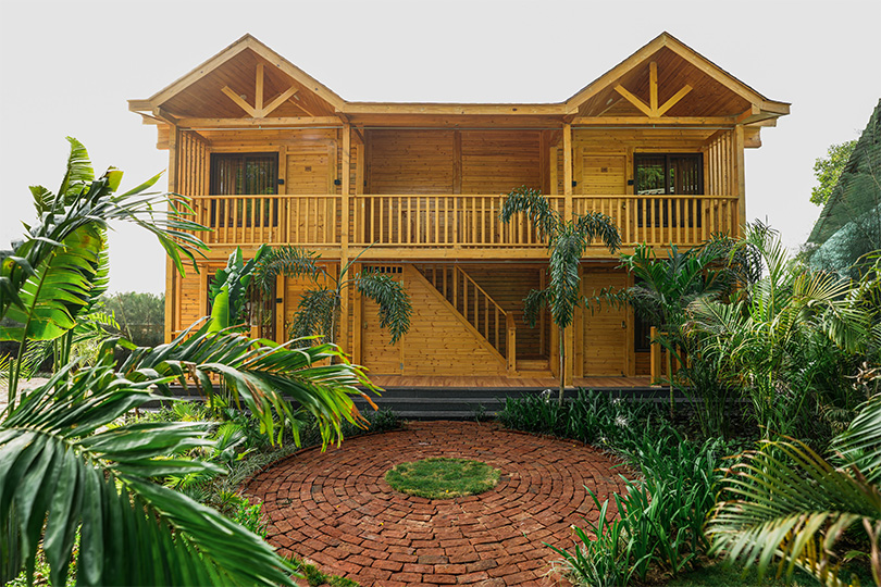 Main landing image showing the front view of a beautifully crafted wooden cottage at Roadies Rostel ARC Resort, Ahmedabad.