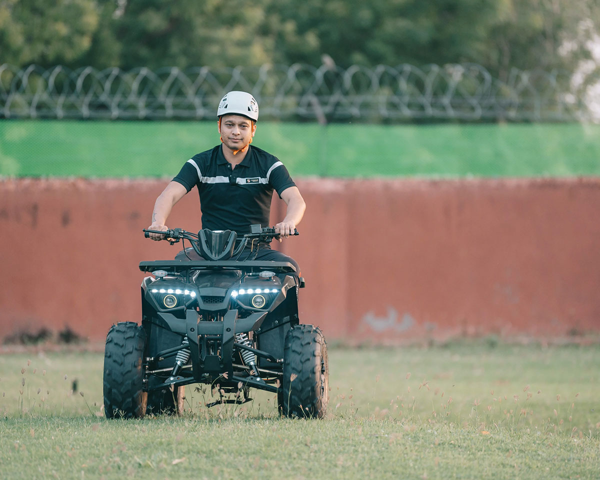 Guest enjoying an ATV ride on the adventure track at Roadies Rostel ARC Resort Ahmedabad