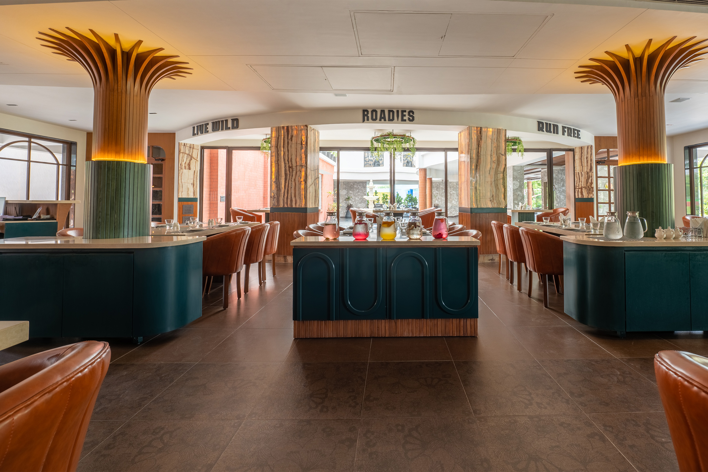 Elegant interior view of Samyati restaurant at the best resort in Ahmedabad, featuring warm ambient lighting and sophisticated wooden décor