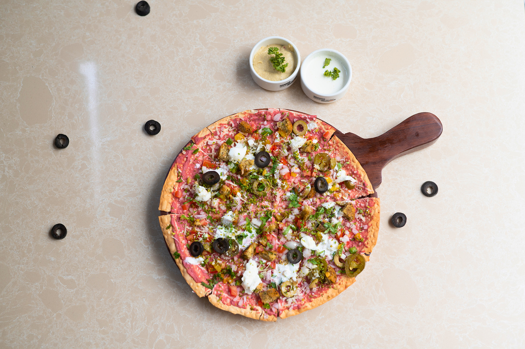 Freshly baked pizza served hot at Samyati restaurant, a must-try dining spot at the best resort in Ahmedabad.