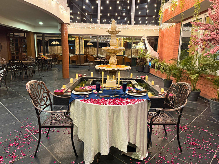 Candle-lit arrangement beside the fountain for an intimate celebration at one of the best outdoor event venues near Ahmedabad.