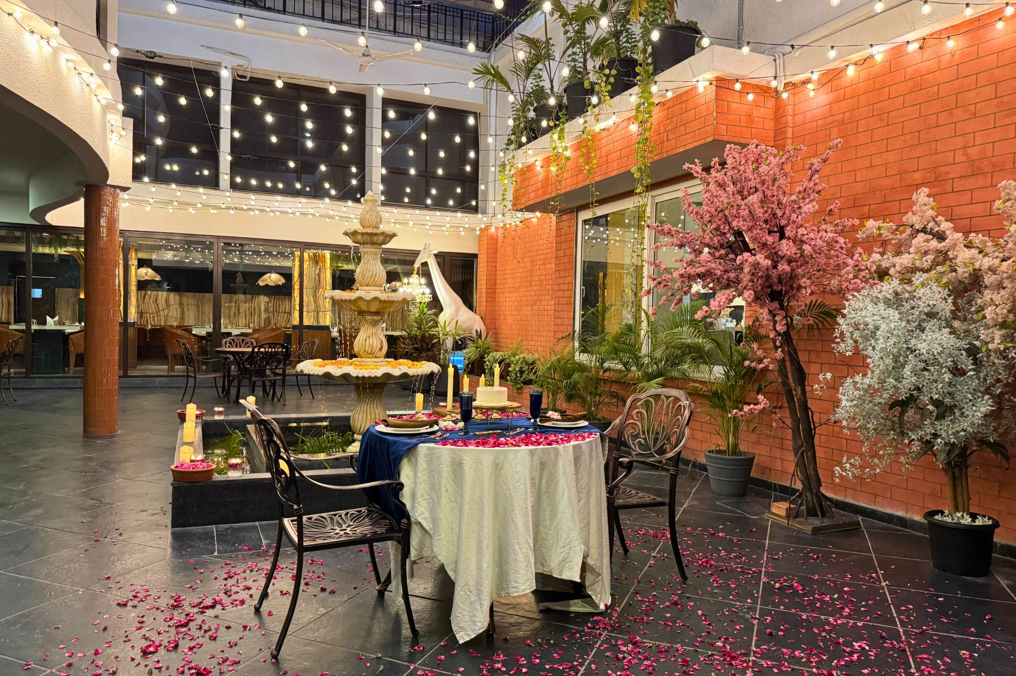 Evening dining setup near the fountain at one of the best resorts near Ahmedabad for intimate celebrations.