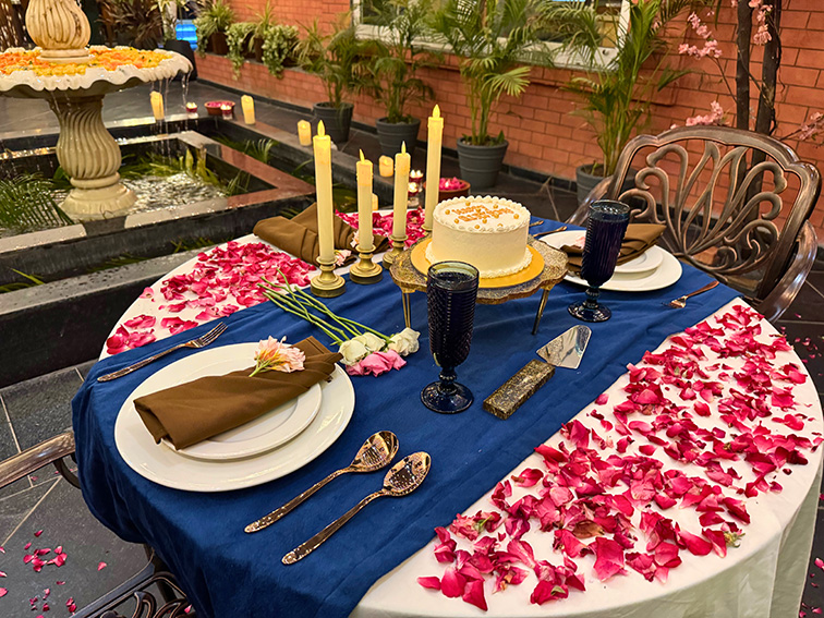 Floral decorations set up for a celebration beside the fountain at The Neer, offering a serene setting at Roadies Rostel ARC Resort near Ahmedabad.