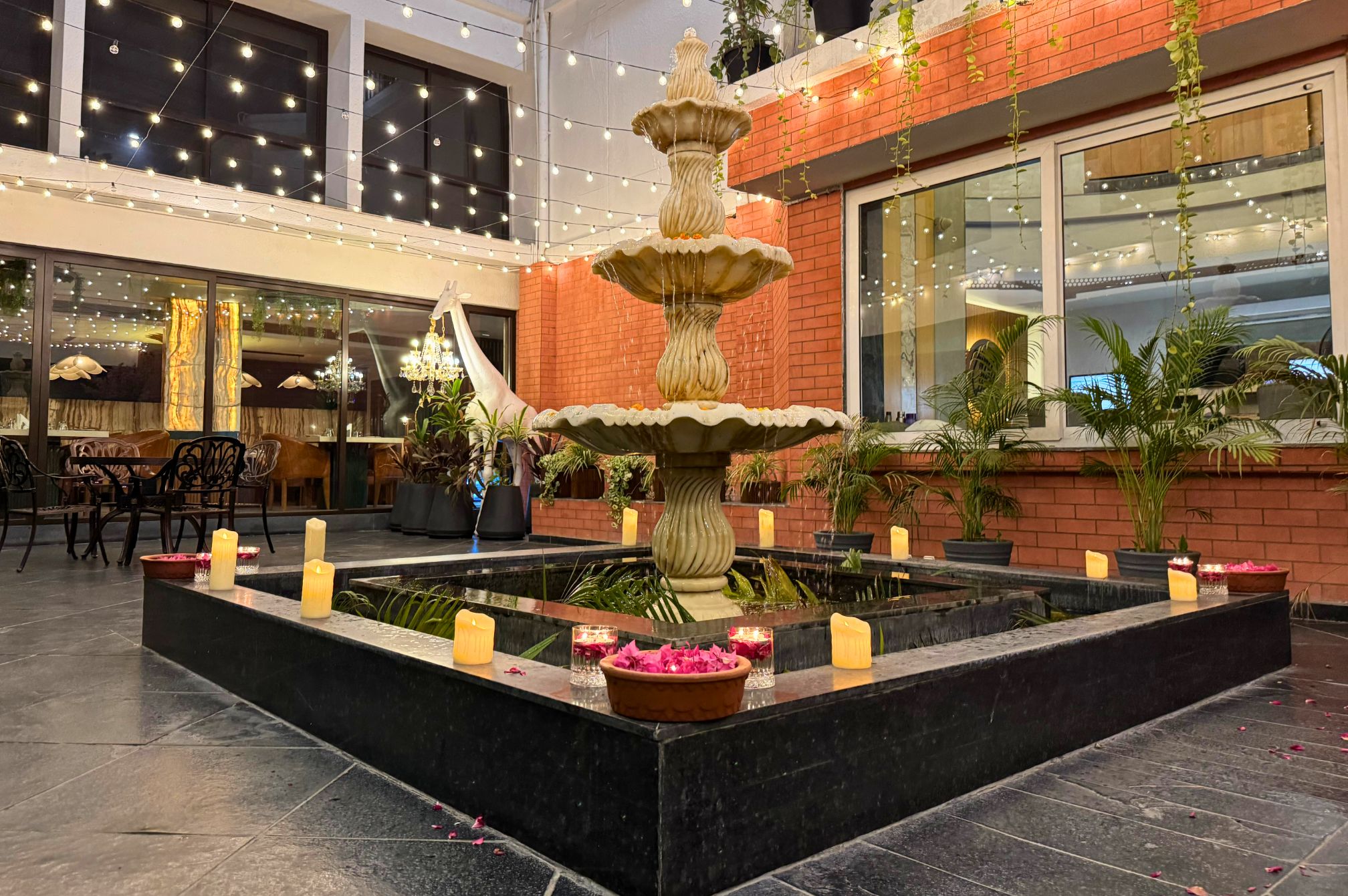 Decorated celebration area beside the fountain at The Neer, a peaceful and stylish outdoor venue near Ahmedabad.