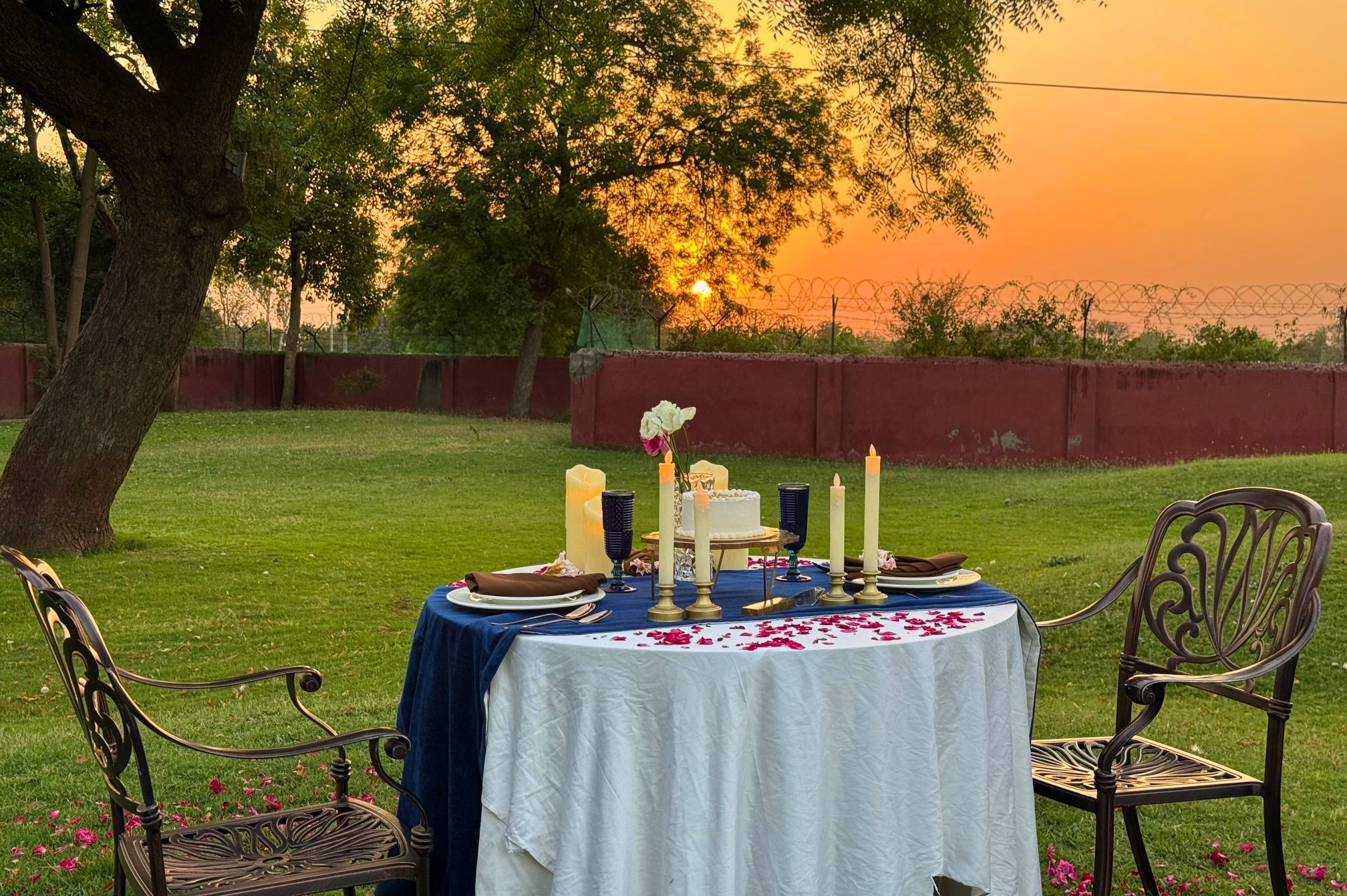Intimate garden dining arrangement during sunset at one of the best resorts near Ahmedabad for private celebrations.
