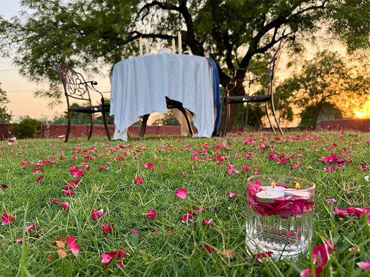 Close-up of floral and candle decor used for lawnside celebrations at Roadies Rostel ARC Resort near Ahmedabad.