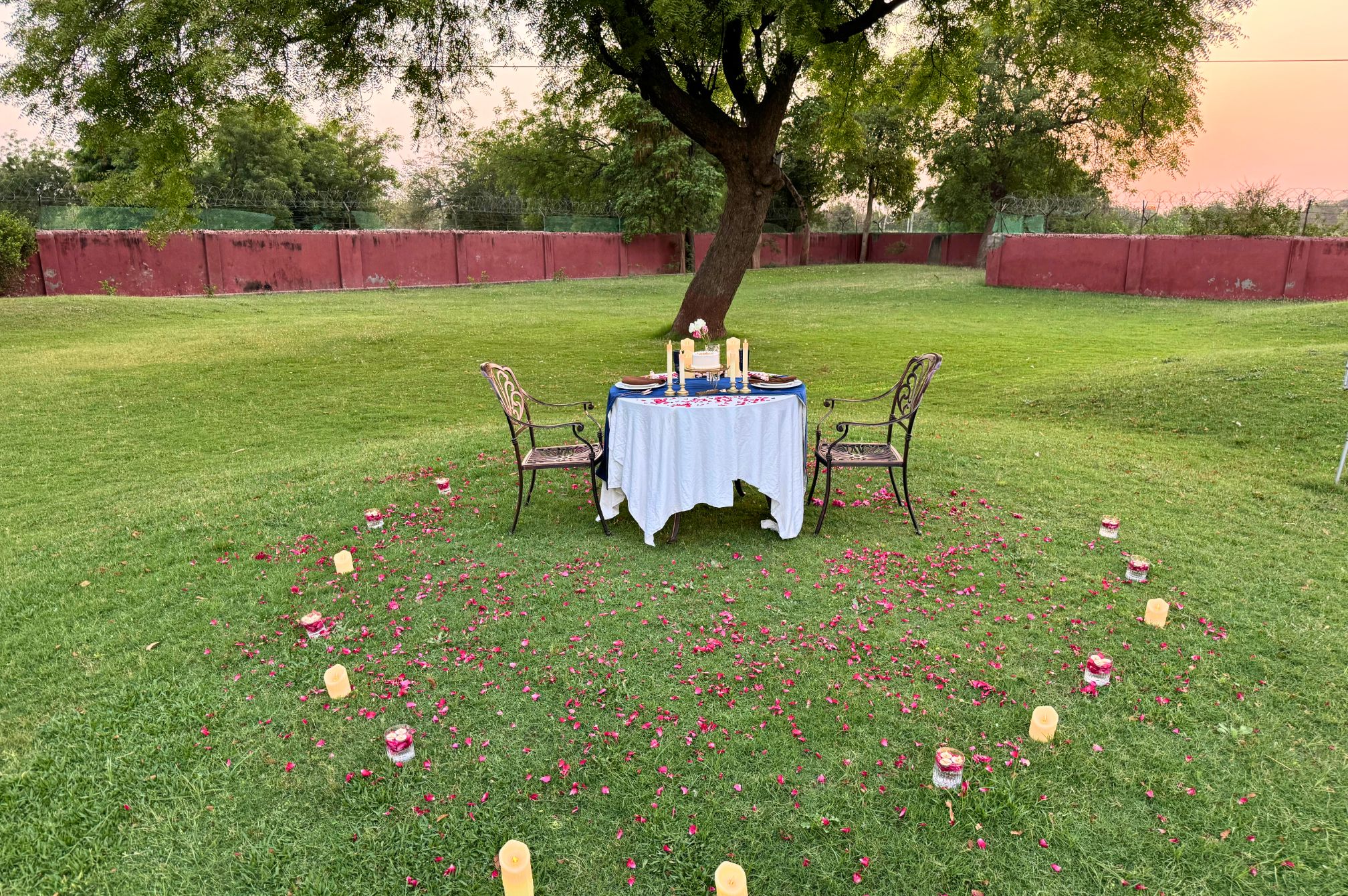 Golden hour garden celebration setup with decorated tables, perfect for outdoor events at a resort near Ahmedabad.