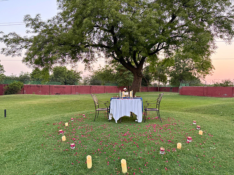 Beautiful lawnside table setup for outdoor celebrations at one day picnic resort near Ahmedabad.