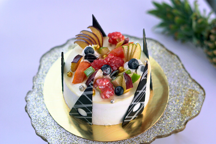 Celebration cake placed by the poolside at Roadies Rostel ARC Resort Ahmedabad, perfect for birthdays and special moments near Ahmedabad.