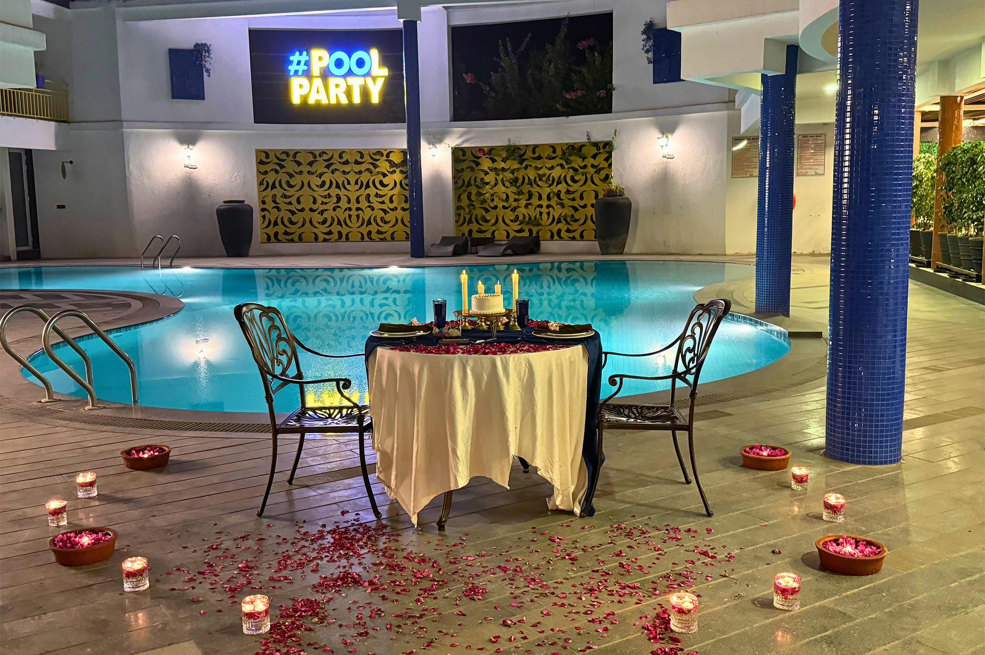 Floral-themed festive poolside setup at a luxury resort near Ahmedabad, ideal for birthdays, anniversaries, and special events.