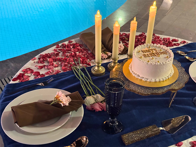 Elegant table setup for a private poolside celebration at a top resort near Ahmedabad, ideal for intimate events and gatherings.