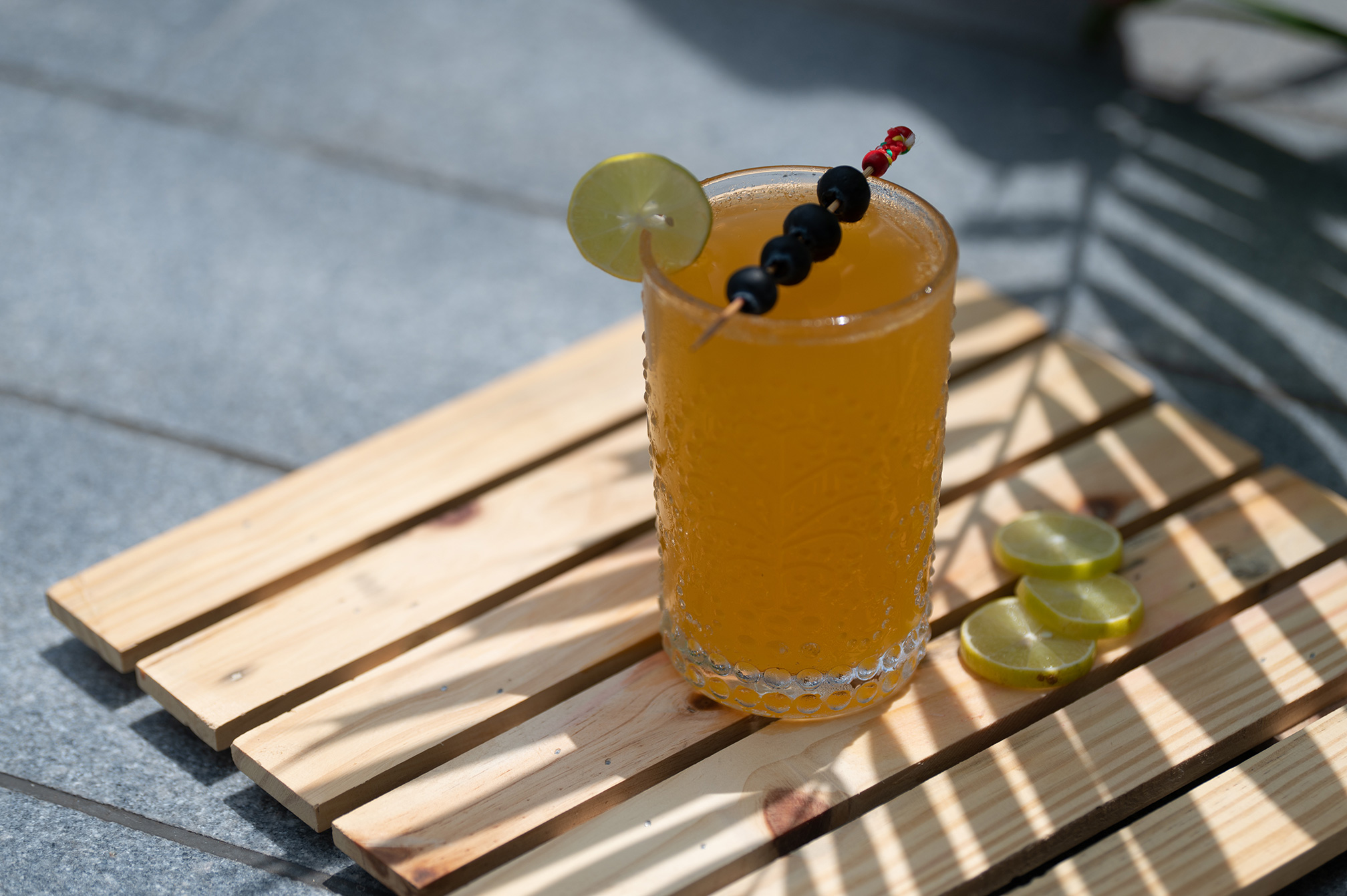 Close-up of a citrus-based mocktail served fresh at The Nest bar, ideal for guests seeking a cool and flavorful drink experience near Ahmedabad.