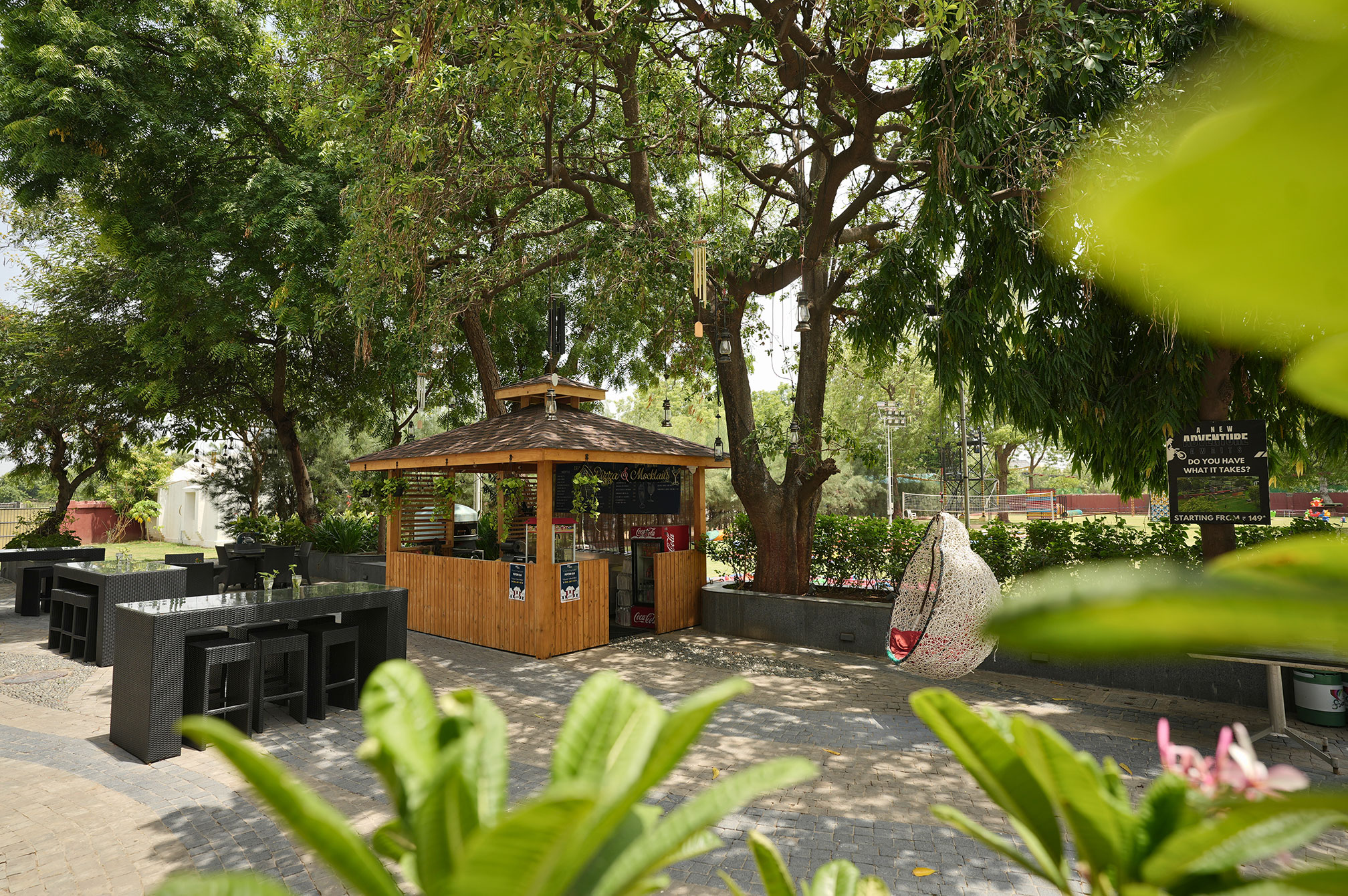The Nest mocktail bar counter at Roadies Rostel ARC Resort, showcasing rustic design and lively beverage service near Ahmedabad.