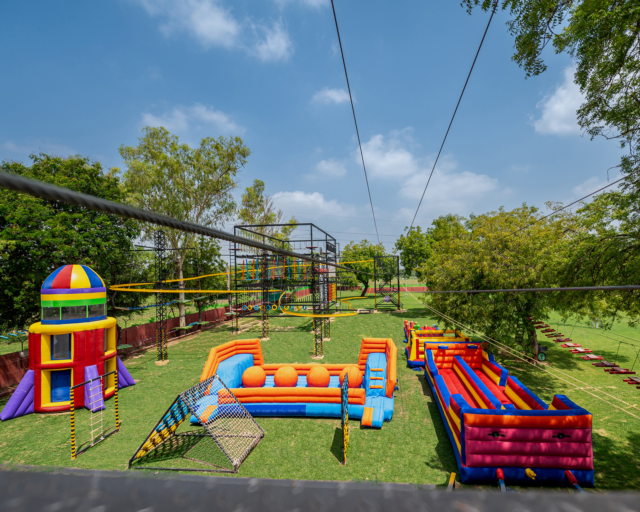 Aerial view of Roadies Rostel Adventure Park featuring ziplines, rope courses, inflatables, and kids play zones