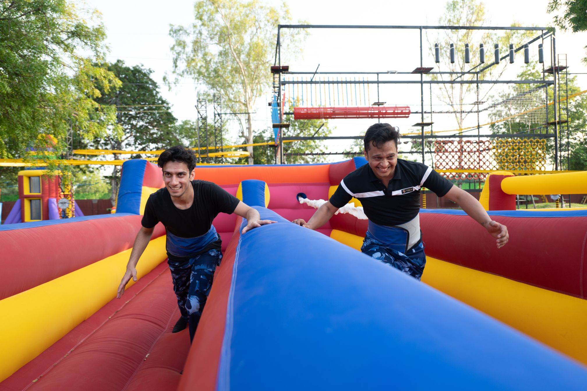 Guests navigating colorful inflatable race obstacle at Roadies adventure park