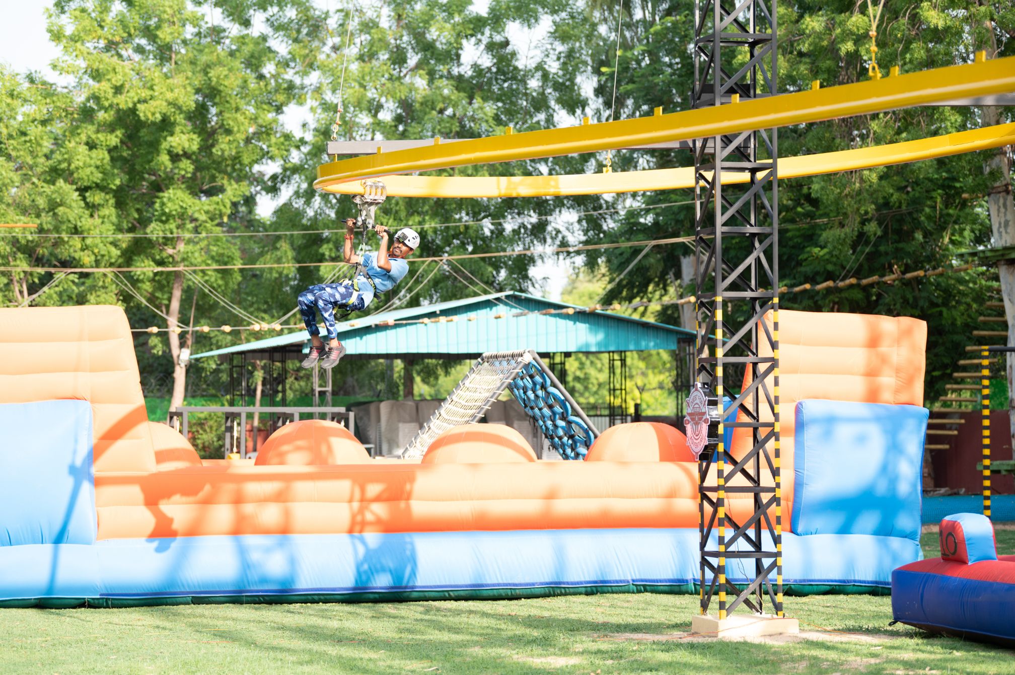 Guest mid-air on the signature rollercoaster zipline at Roadies Rostel