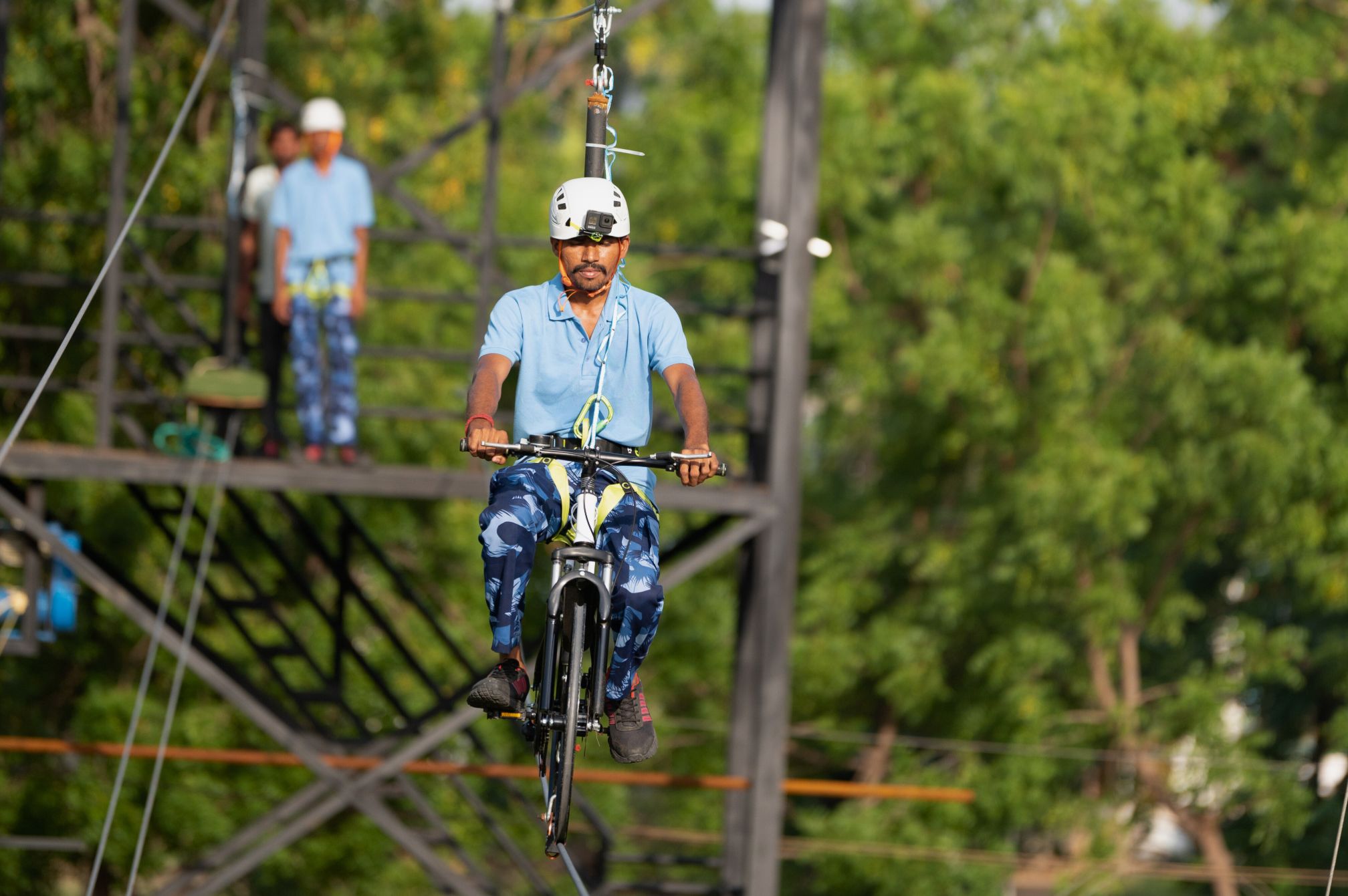 Guest balancing on the sky cycle zipline ride at Roadies Rostel ARC Resort adventure zone