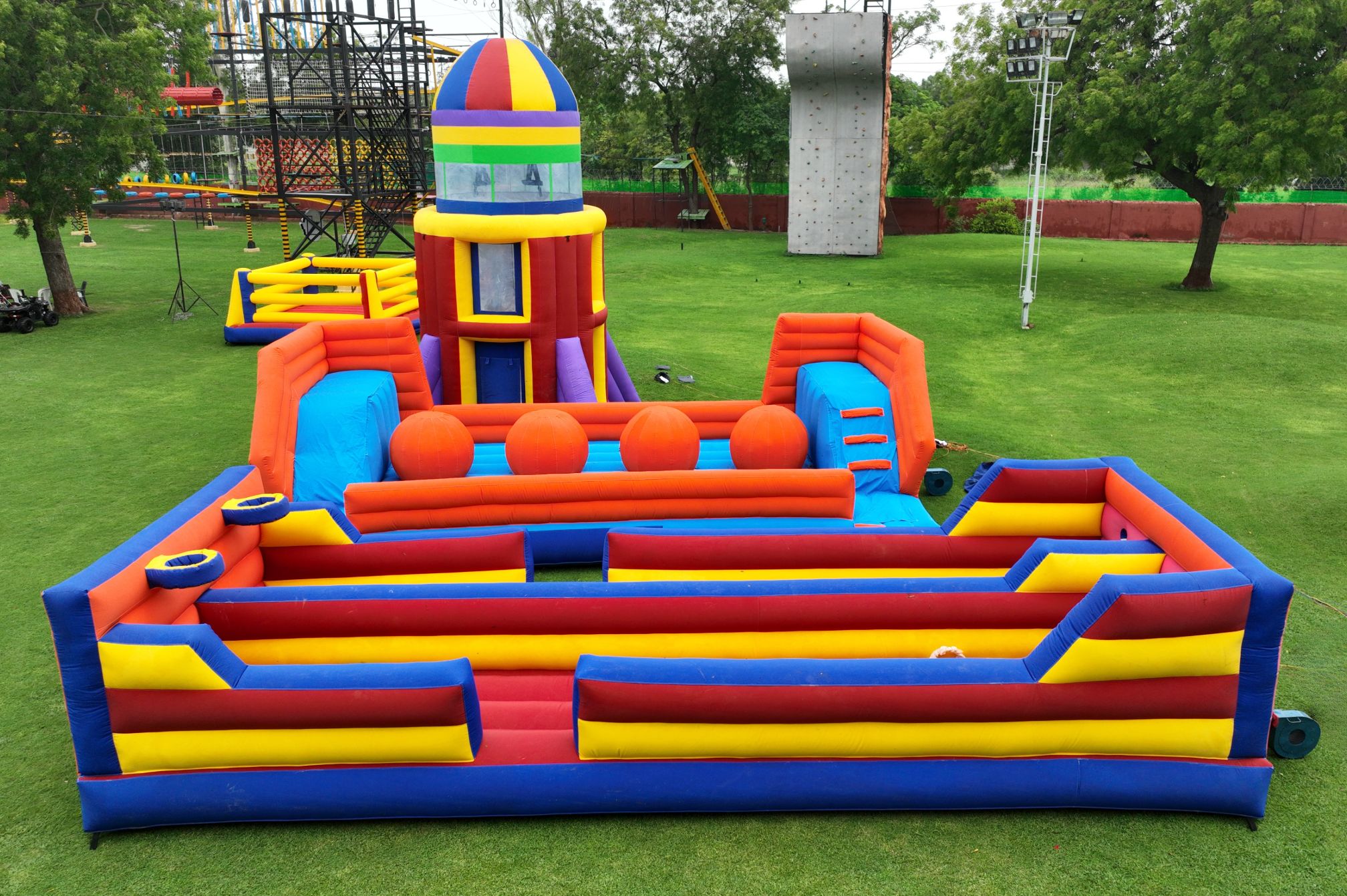 Brightly colored inflatable obstacle course and rocket slide at Roadies Rostel ARC Resort in Ahmedabad for kids and adults