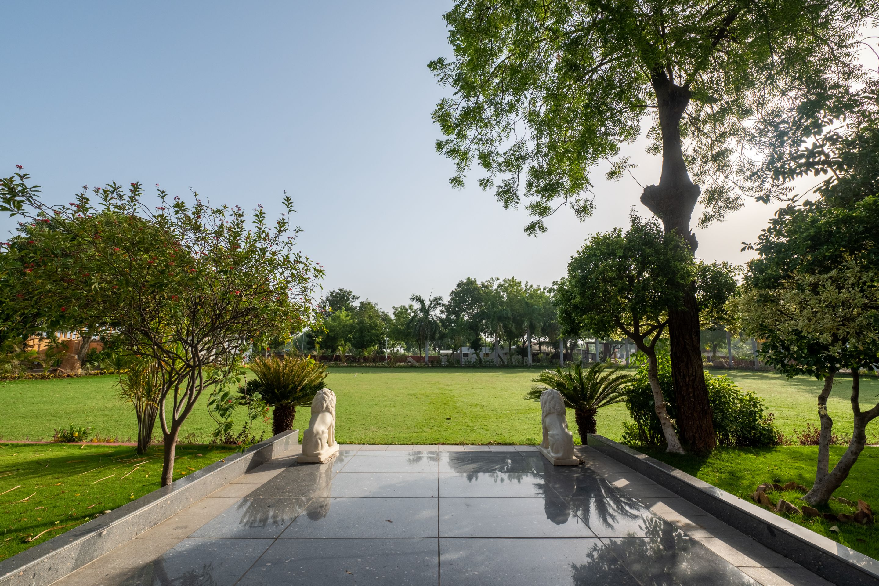 Spacious green lawn at Roadies Rostel ARC Resort near Ahmedabad ideal for outdoor events and picnics