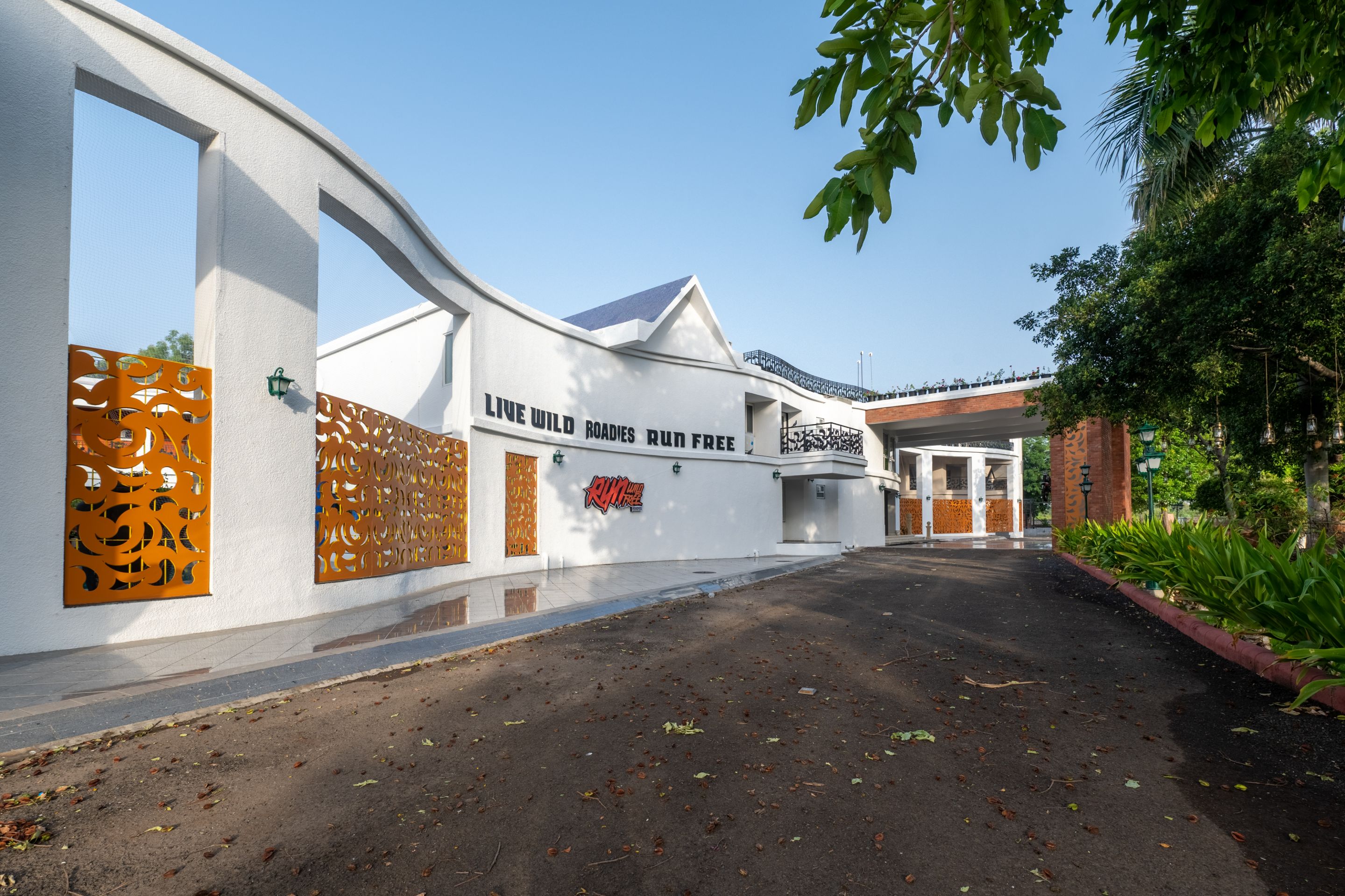 Stylish main entrance of Roadies Rostel ARC Resort with modern design and welcoming architecture near Ahmedabad