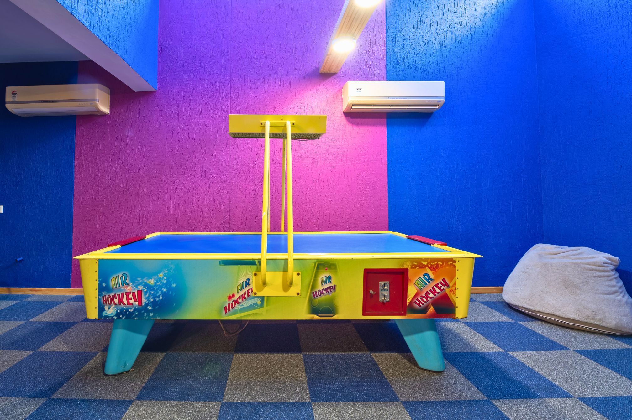 Air hockey game setup in vibrant den area at resort