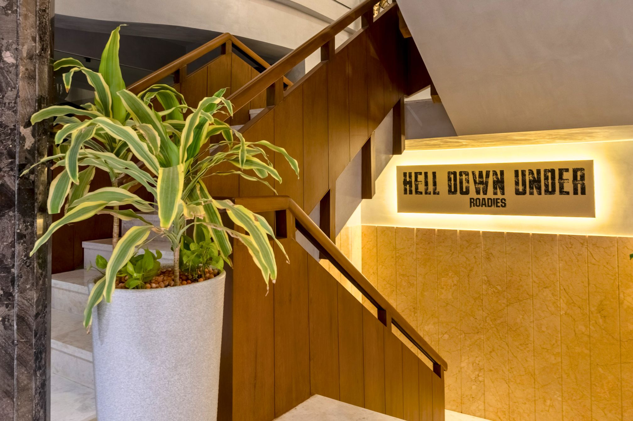 Hell Down Under sign at staircase entrance in Roadies Rostel Den area