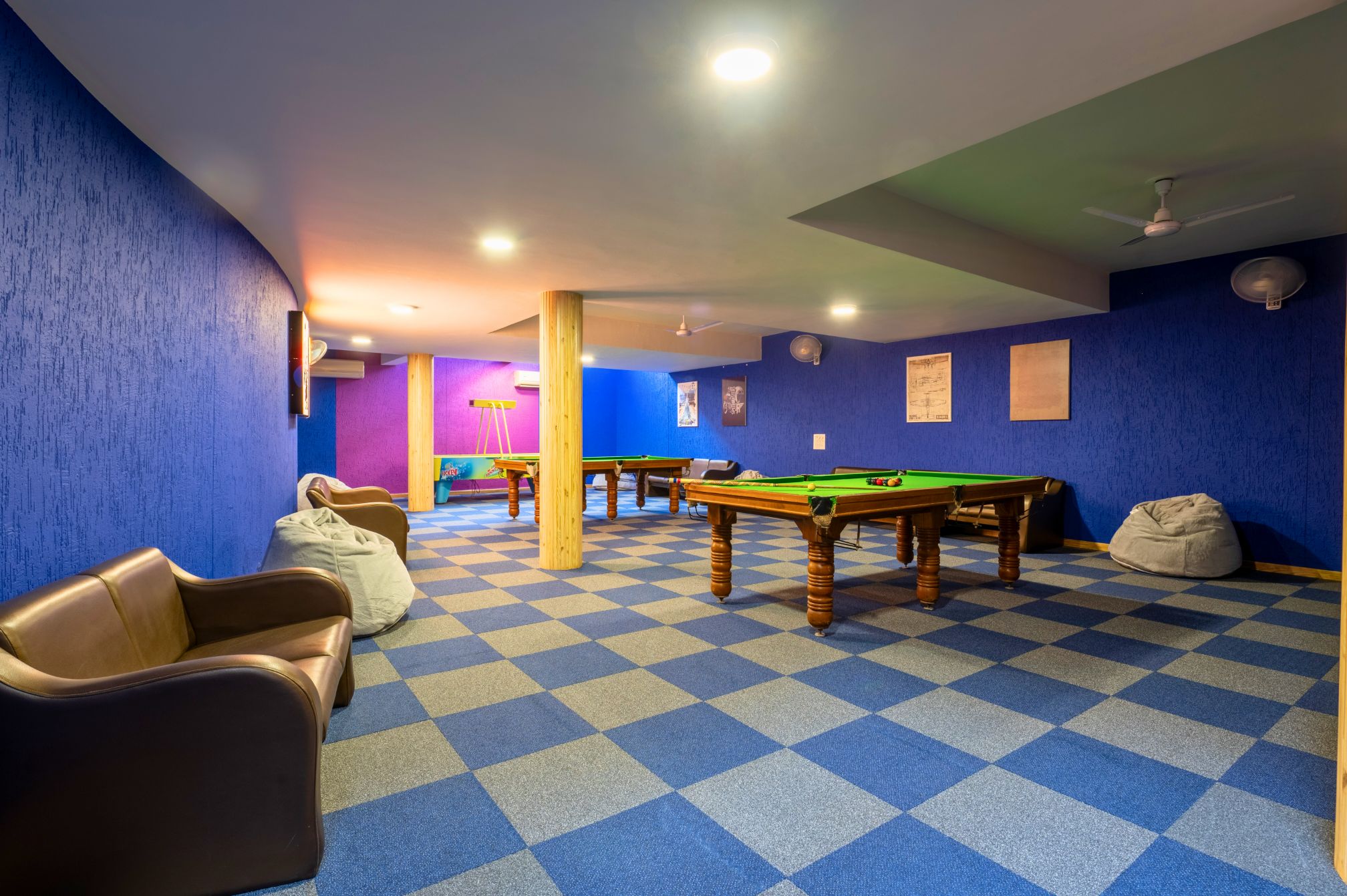Spacious indoor snooker room at Roadies Rostel resort with vibrant blue walls