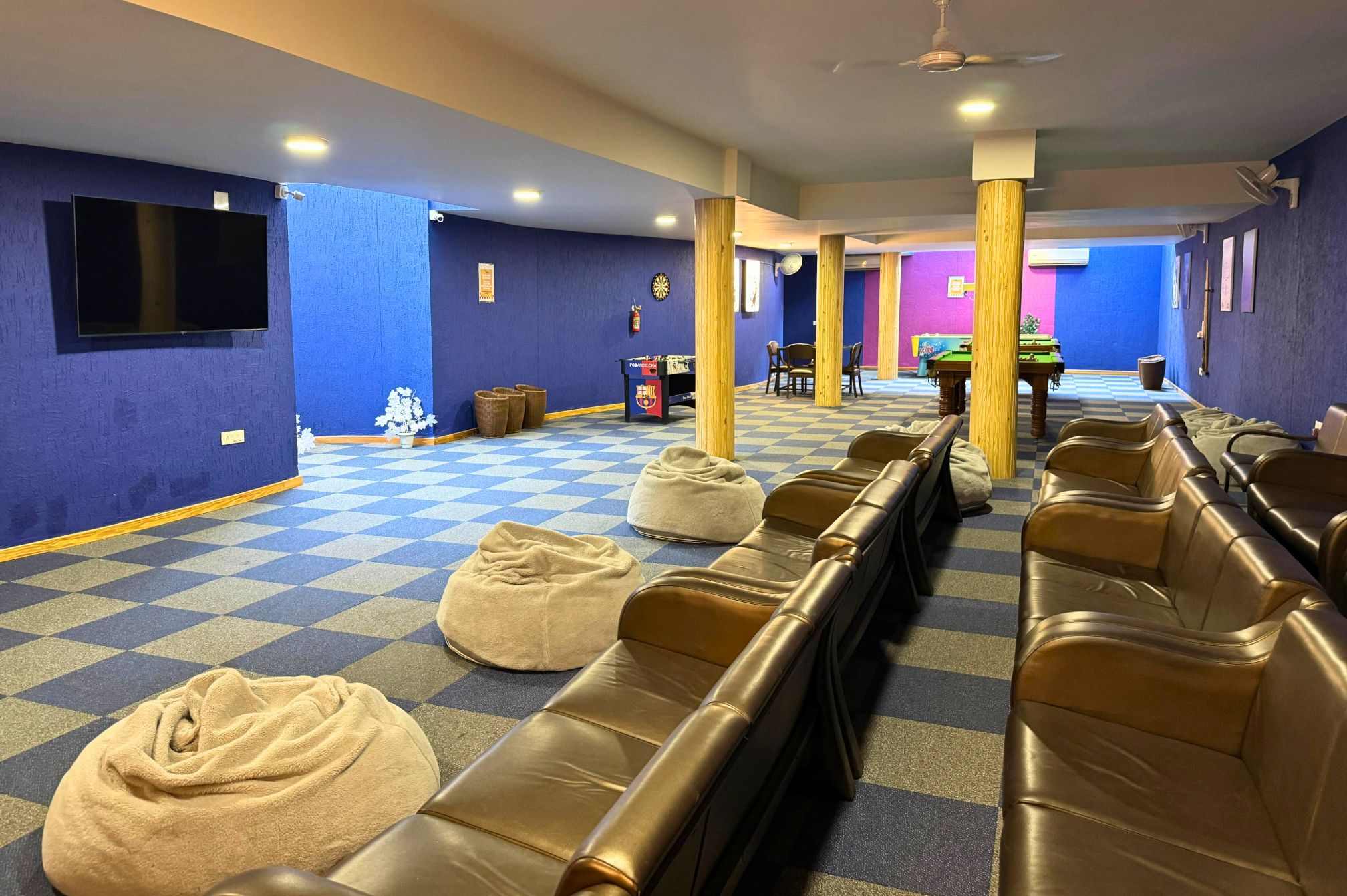 Movie screening and lounge seating in the Den area of the resort