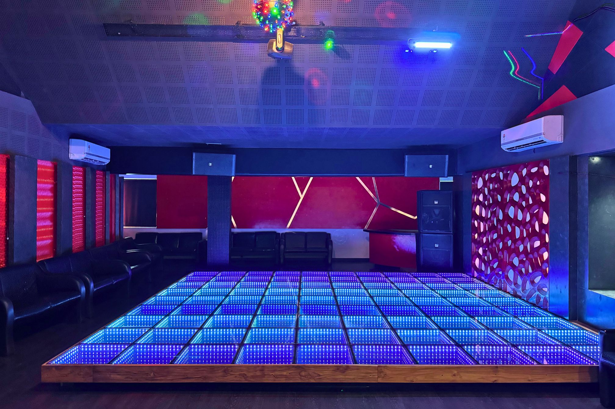 Spacious LED-lit discotheque dance floor ideal for group celebrations at Roadies Rostel ARC Resort