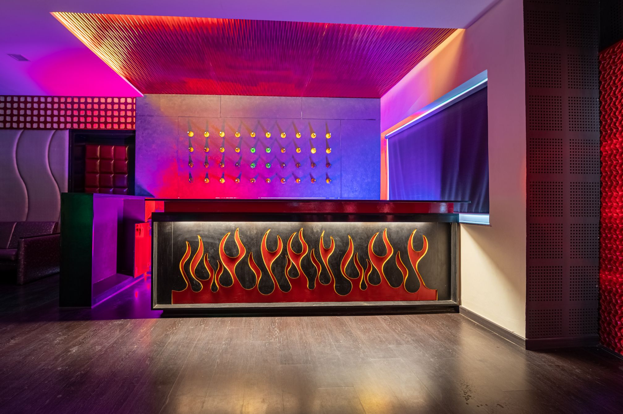 Stylish DJ bar counter with neon lighting, ideal for nightlife experiences at Roadies Rostel