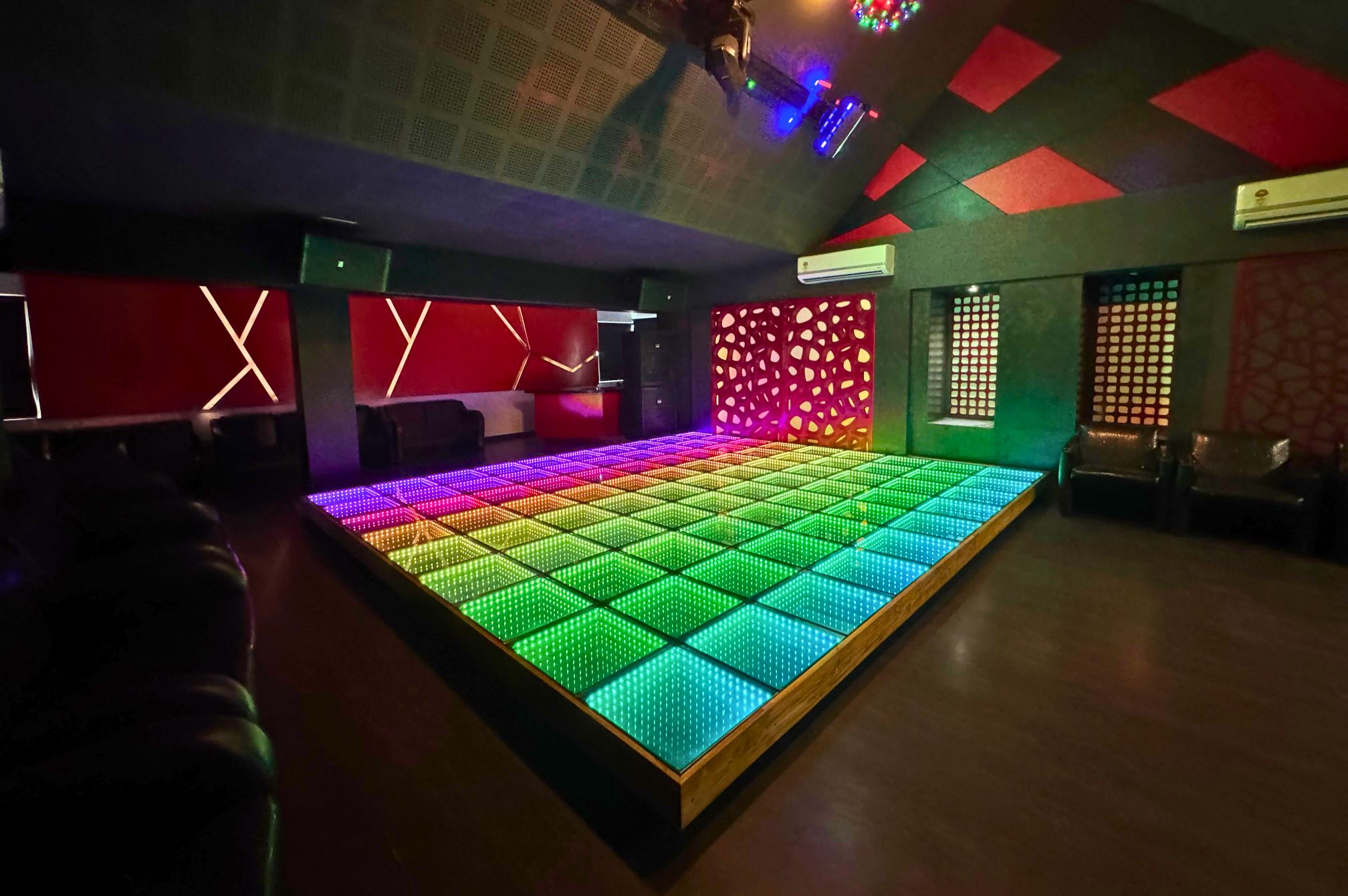 Green and blue LED disco floor setup for private party bookings at Roadies Rostel ARC Resort
