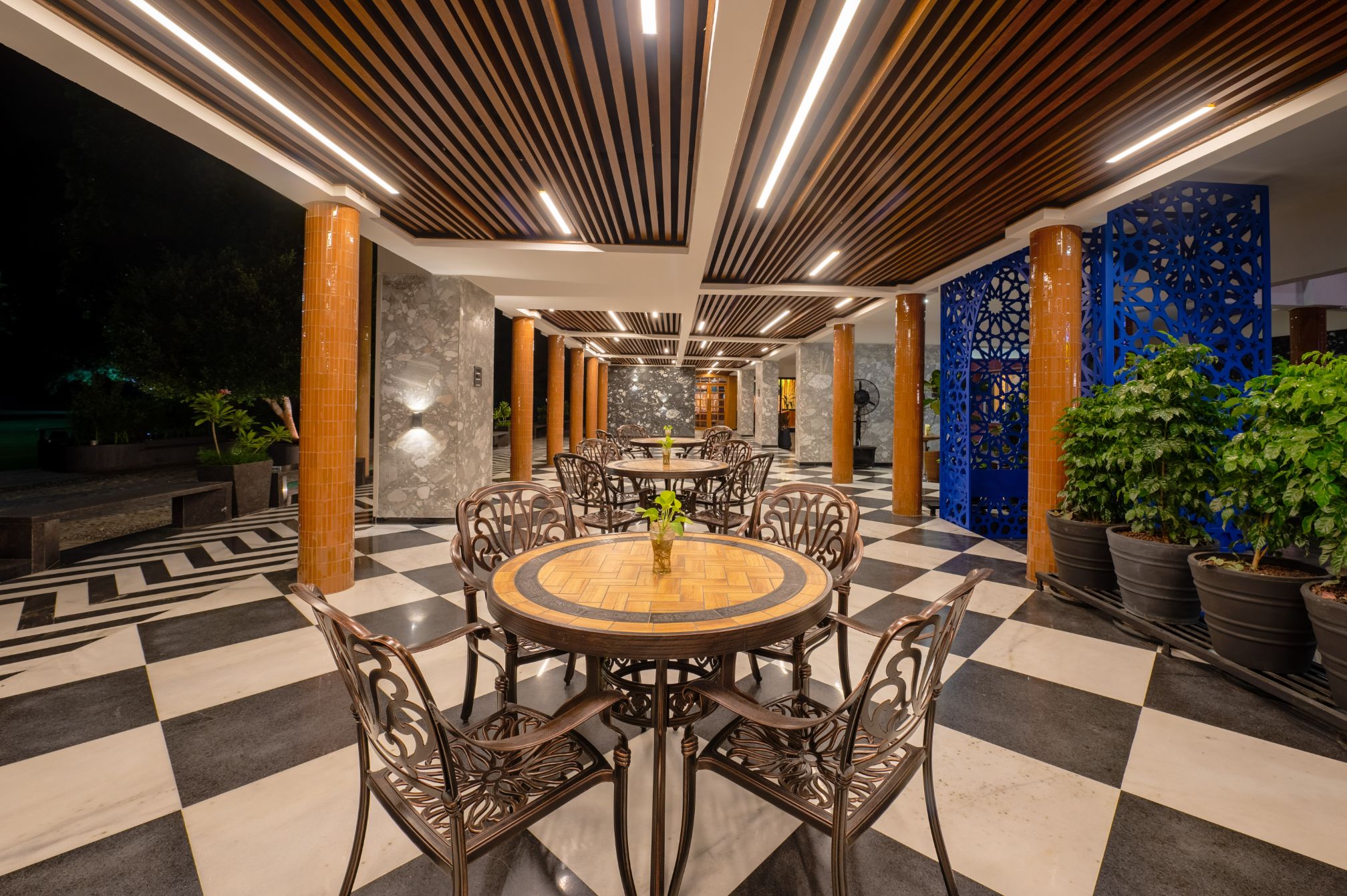 Chic outdoor dining setup with elegant black and white flooring at Roadies Rostel ARC Resort, a luxury resort near Ahmedabad.