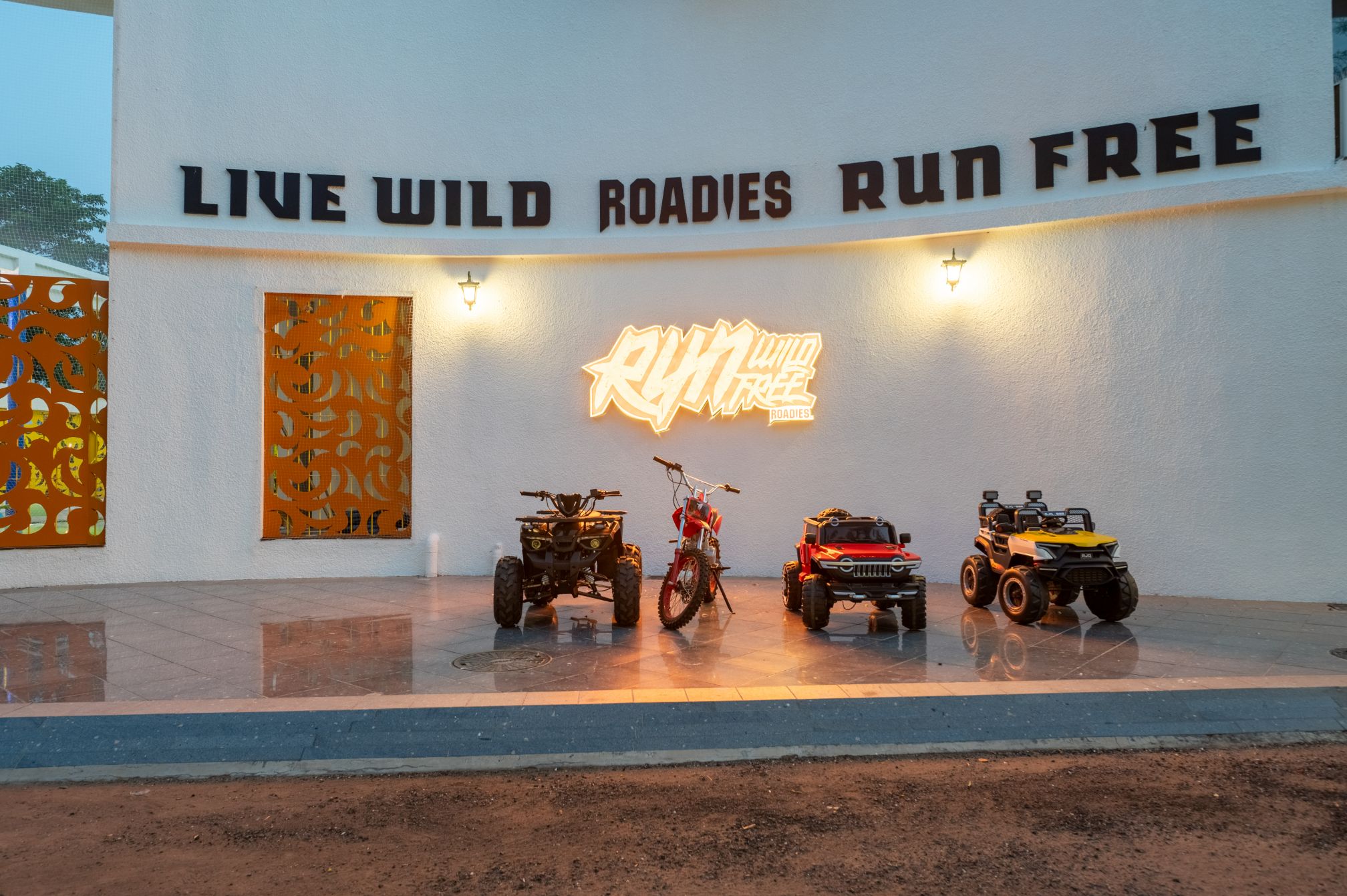 Adventure-themed kids vehicle display at Roadies Rostel ARC Resort Ahmedabad