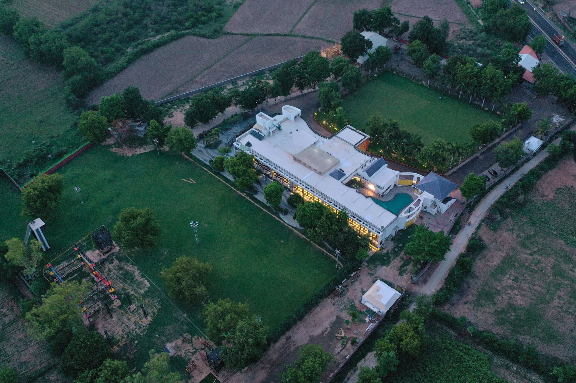 Aerial view of Roadies Rostel ARC Resort surrounded by greenery near Ahmedabad