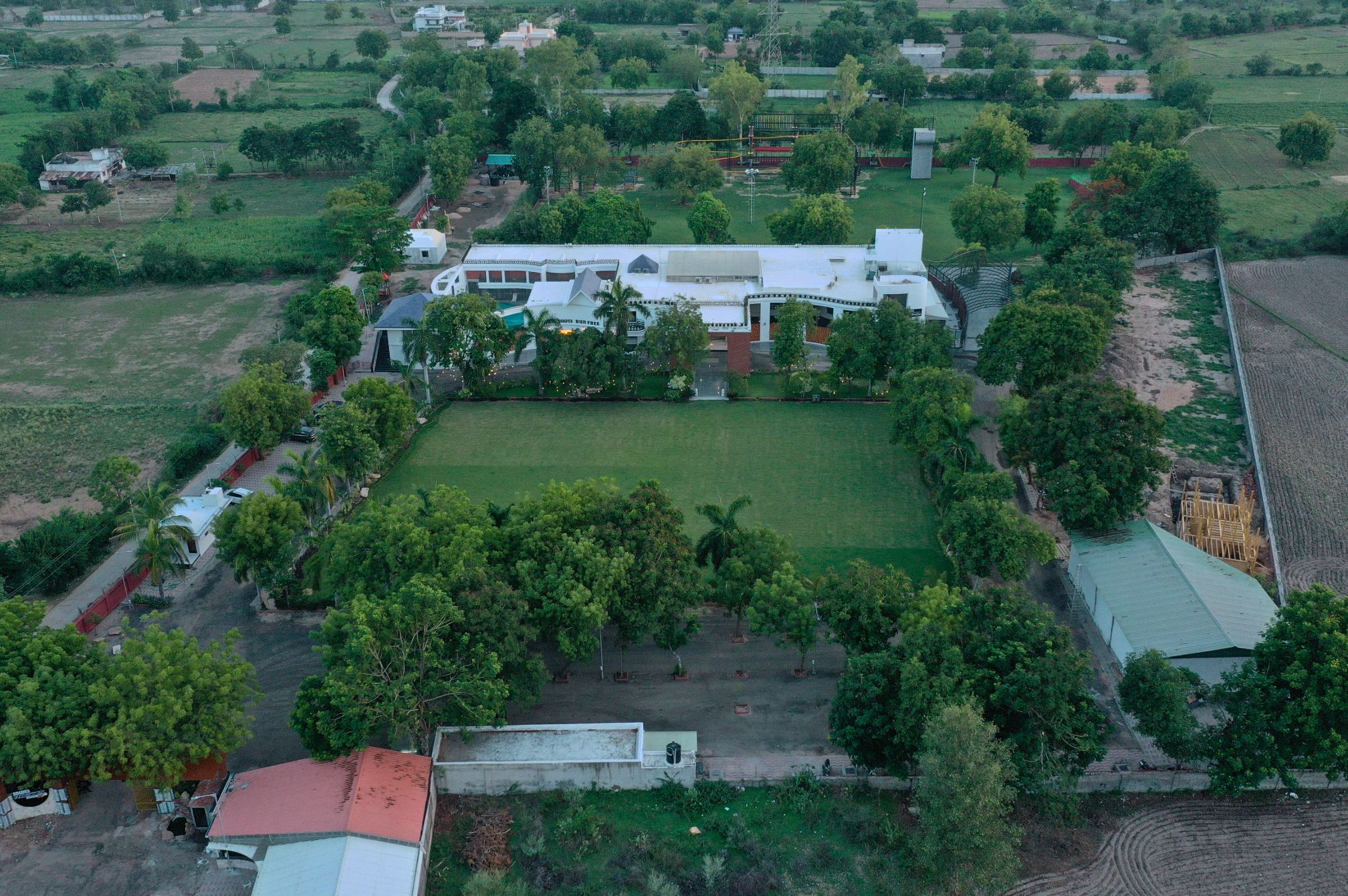 Aerial view of Roadies Rostel ARC Resort surrounded by greenery, ideal for a peaceful resort stay near Ahmedabad.