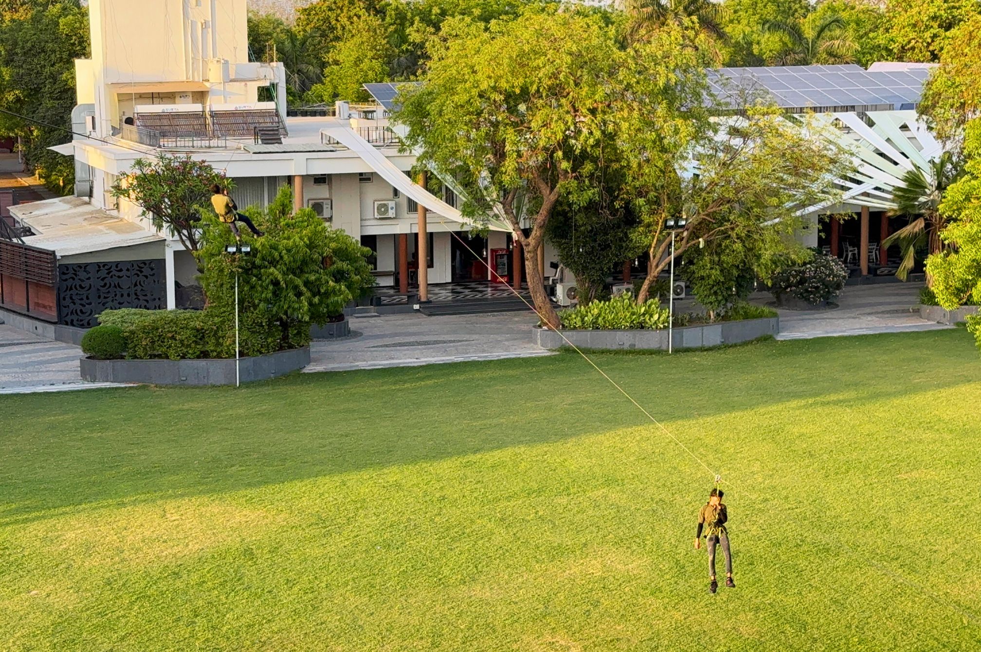 Zipline ride across open lawn at Roadies Rostel ARC Resort adventure park near Ahmedabad