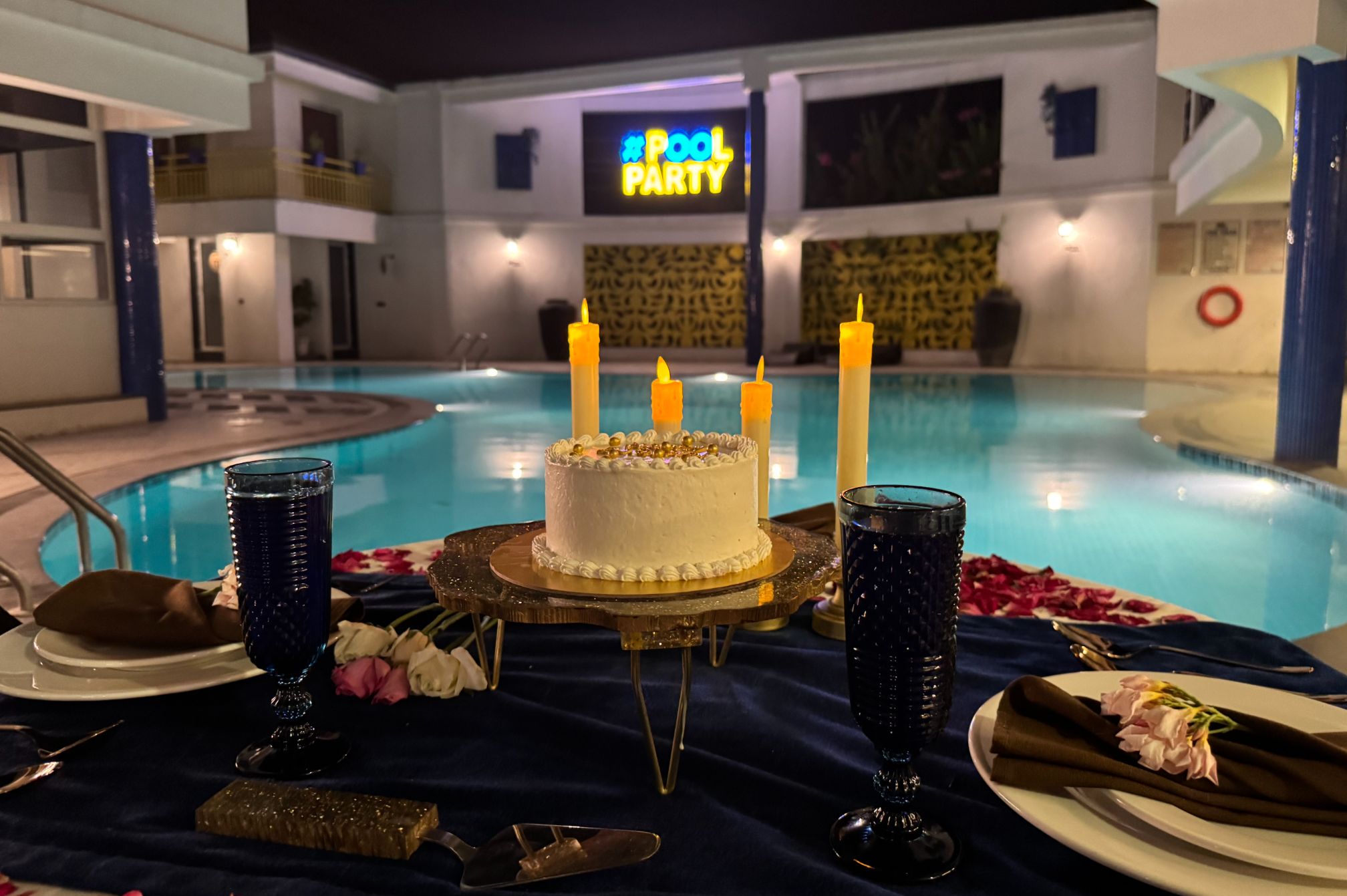 Candlelight romantic dinner setup by the pool at Roadies Rostel, ideal for couple celebrations and anniversaries