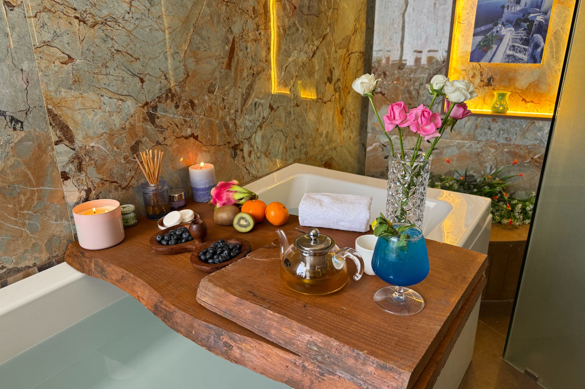 Bathtub corner with romantic tray setup including wine and snacks, available at Roadies Rostel Superior Room