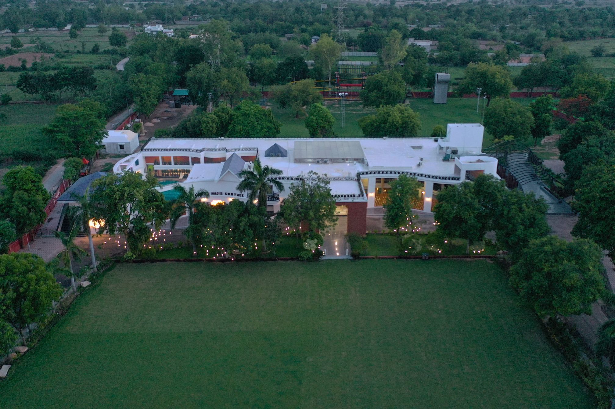 Aerial view of Roadies Rostel ARC Resort showcasing expansive greenery and celebration spaces near Ahmedabad