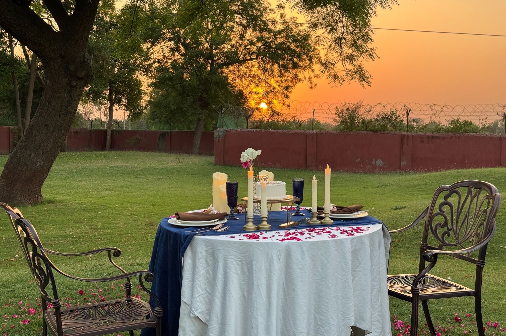 Private romantic dinner setup on the lawn during sunset, ideal for special celebrations and proposals
