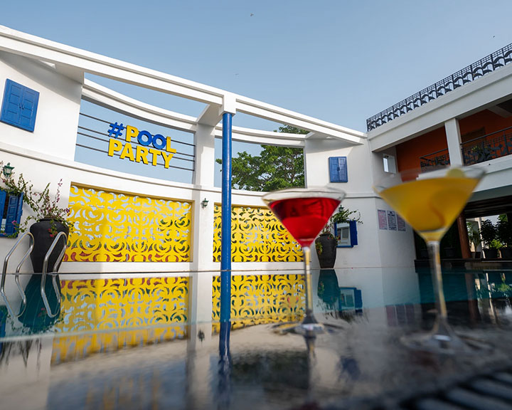 Children playing in the pool at Roadies Rostel ARC, a family resort with swimming facilities near Ahmedabad