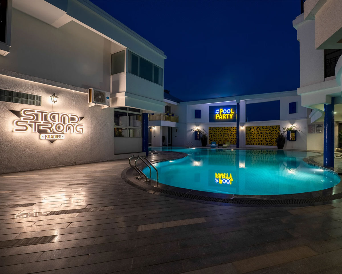 Loungers by the poolside at Roadies Rostel ARC Resort Ahmedabad, ideal for weekend getaways
