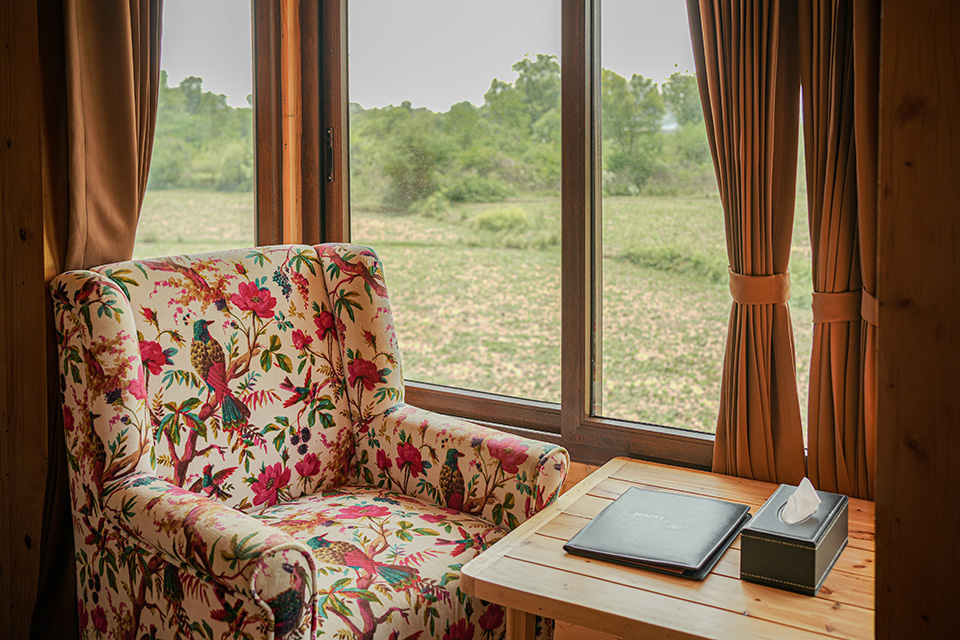 Balcony lounger at Roadies Rostel ARC perfect for unwinding with nature views during a relaxing weekend getaway near Ahmedabad