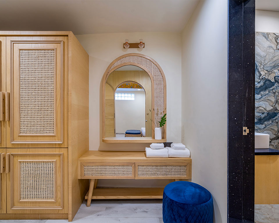 Cane wardrobe and curved vanity at Roadies Rostel ARC bringing handcrafted charm and soft textures to your room experience